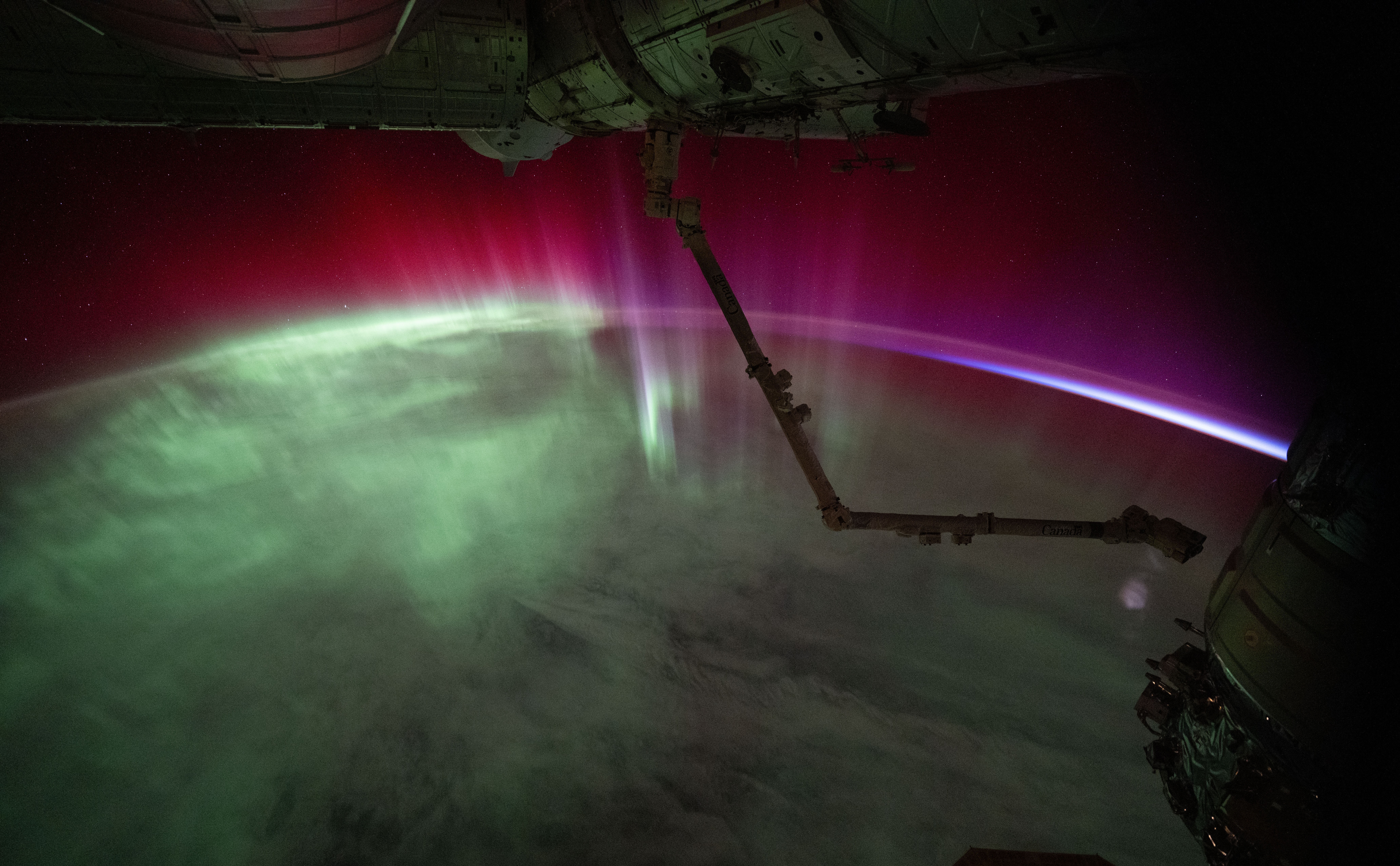 A green and pink aurora seen from space