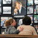 A mourner is comforted near a display of pictures of Billy Graham in Asheville, North Carolina, in 2018. 