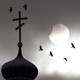 Birds fly past a church spire in front of a partially eclipsed sun.