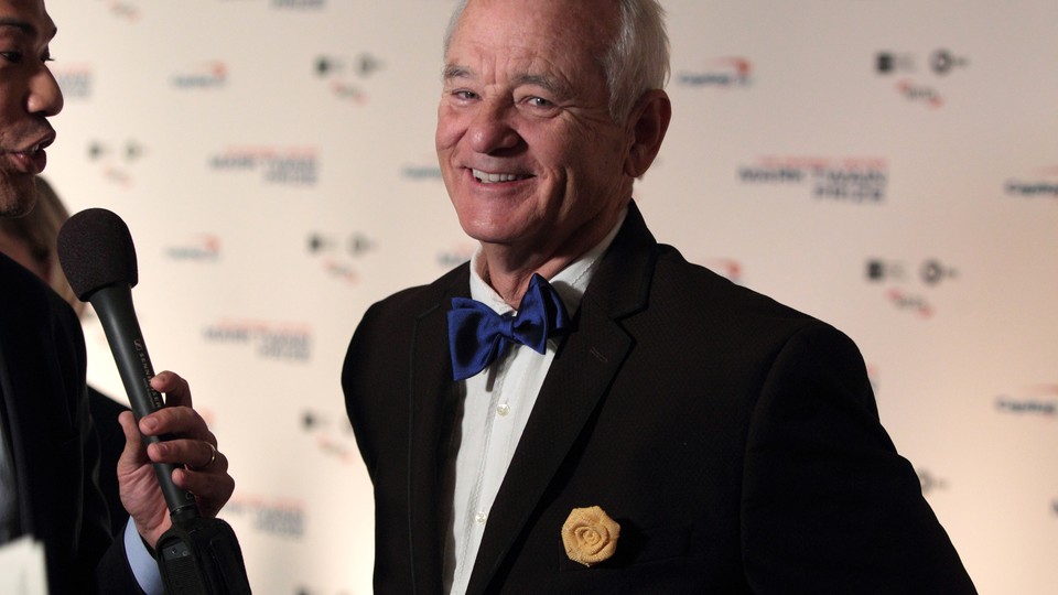 Bill Murray smiles for a camera after arriving at the Kennedy Center for the Performing Arts for the 19th Annual Mark Twain Prize for American Humor presented to Bill Murray on Sunday, Oct. 23, 2016, in Washington.