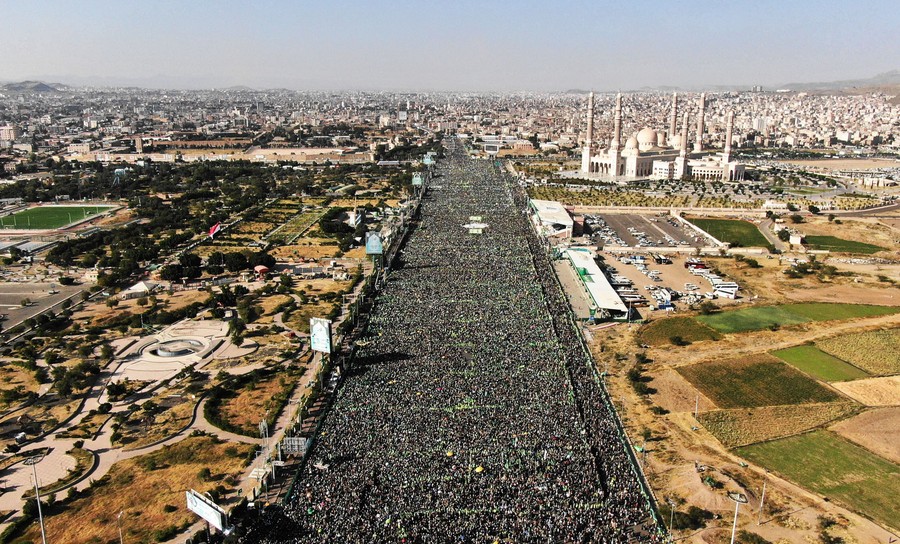 An aerial view of thousands of people gathered in a large public square.