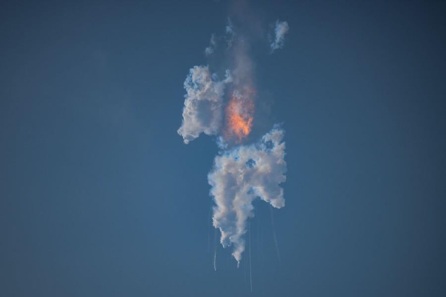 A view of white clouds and a fireball in the sky after the explosion of a rocket.