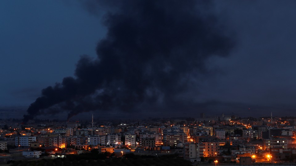 Smoke rises over the Syrian town of Ras al-Ain.