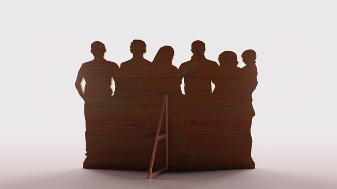 wooden cut out containing the outline of a group of people
