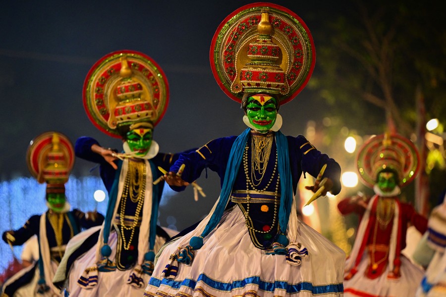 Several dancers perform while wearing traditional masks and costumes.