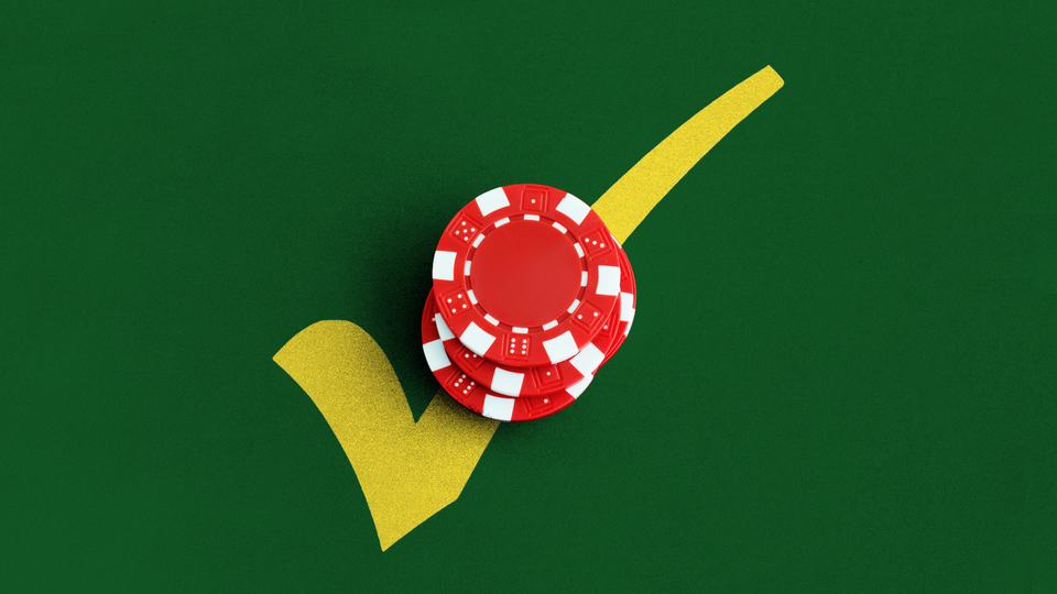 Red poker chips on top of a yellow check mark