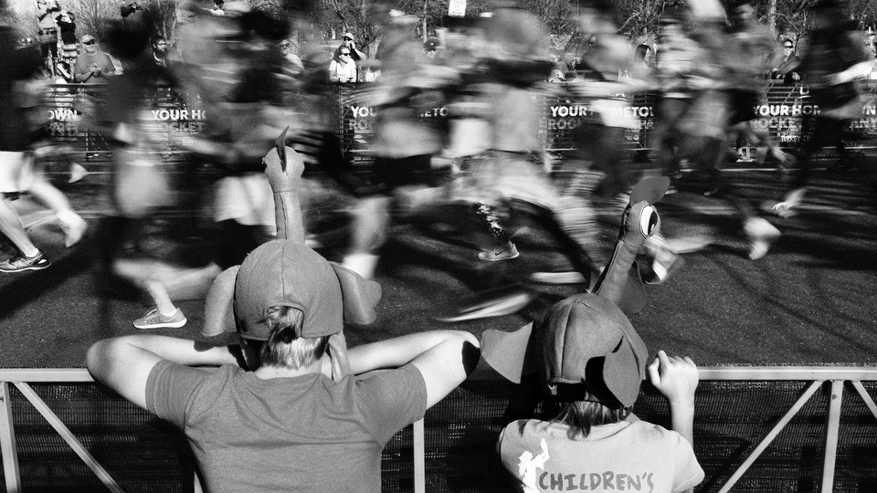 Onlookers cheer on runners at a 2017 Denver turkey trot.