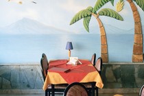 Painting of tropical scene in restaurant in Greece