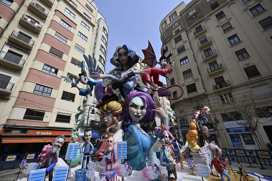 A large installation composed of multiple human and mythical figures in a city square