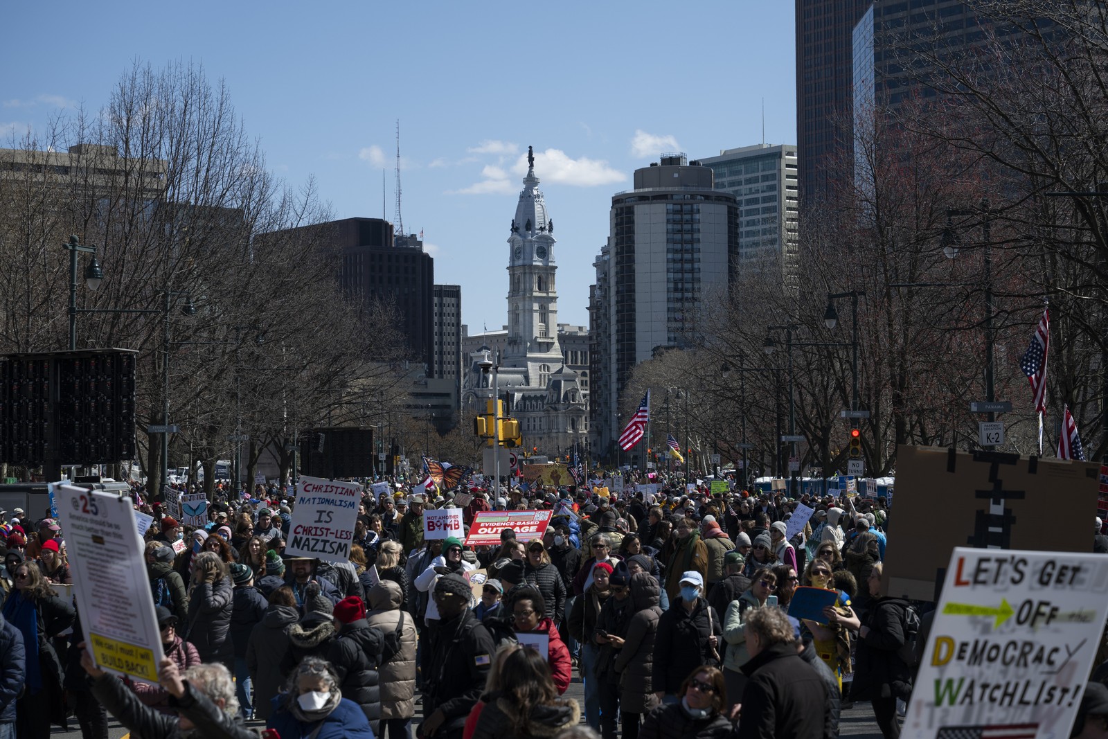 Protesters march down a city street in Philadelphia.