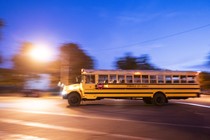 A school bus picks up children in the early morning