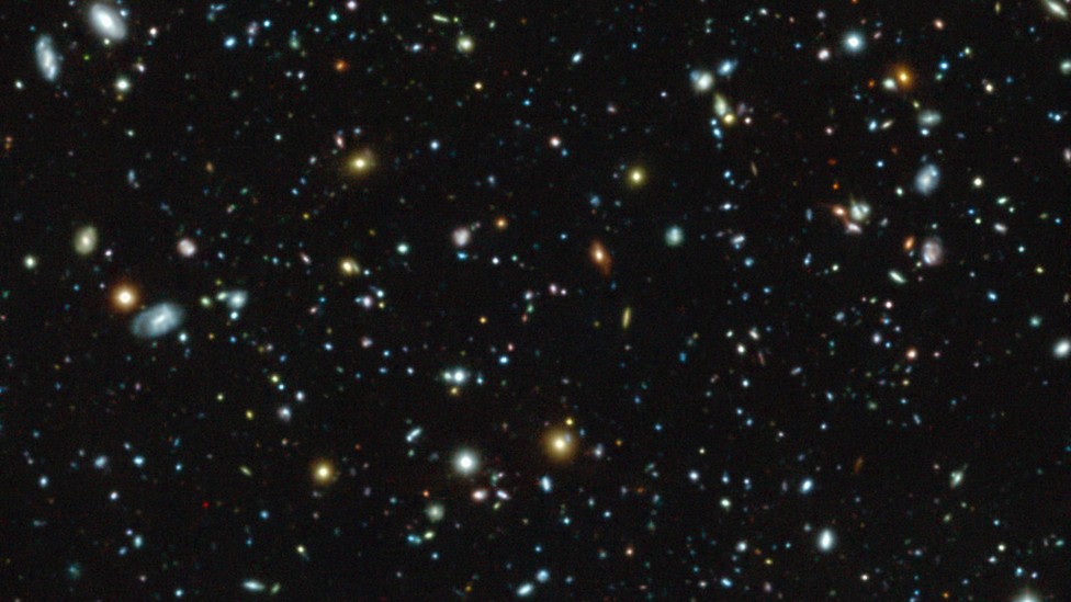 An image of galaxies and star clusters in space