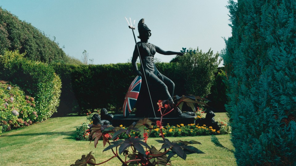 A statue of Britannia in a formal garden
