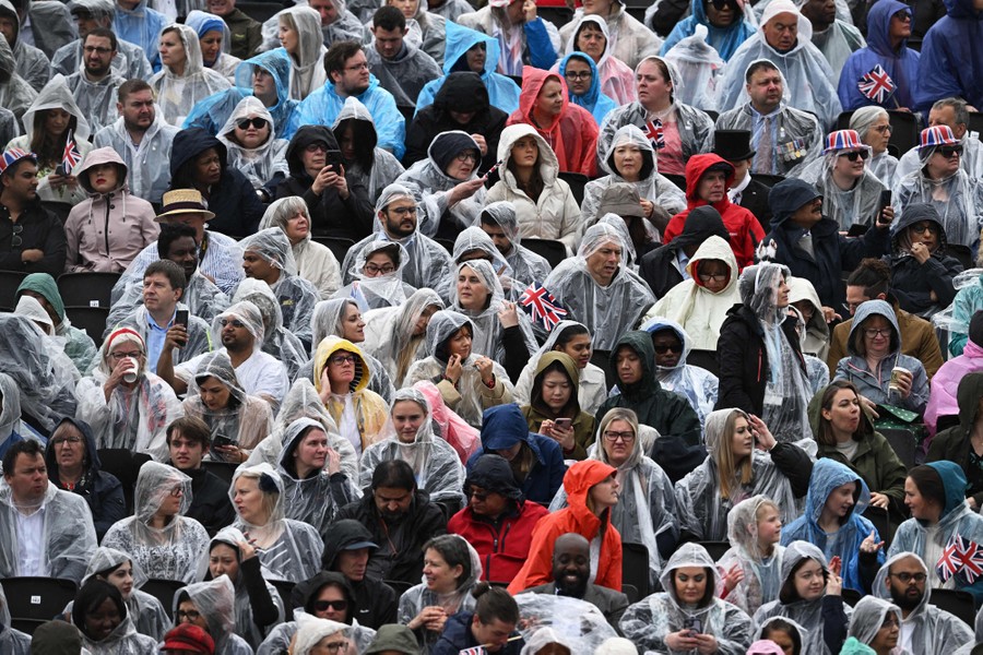 A crowd of people wearing rain ponchos and coats.
