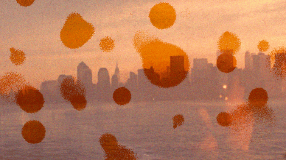 A fuzzy photo of the skyline of NYC with orange circles overlaying
