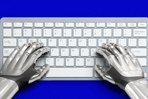 An image of robot hands on a keyboard