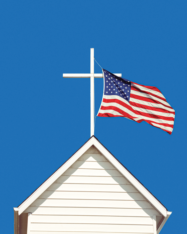 photo-illustration of white cross atop white wooden church steeple with U.S. flag flying from it against blue sky