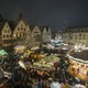 A night view of a bustling Christmas market in a city square in Germany