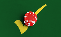Red poker chips on top of a yellow check mark