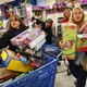 Women at Toys “R” Us hold boxes of toys.
