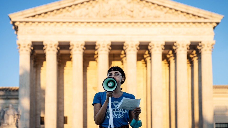 A protester speaking into a megaphone