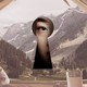 woman looking through keyhole overlaid on tent opening to beautiful valley