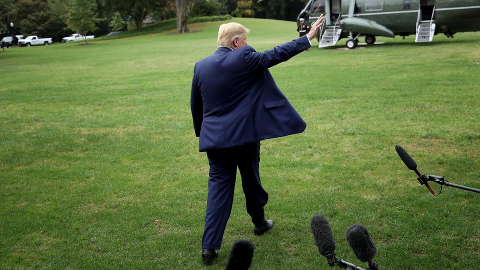 Photo of Trump waving to press as he leaves White House