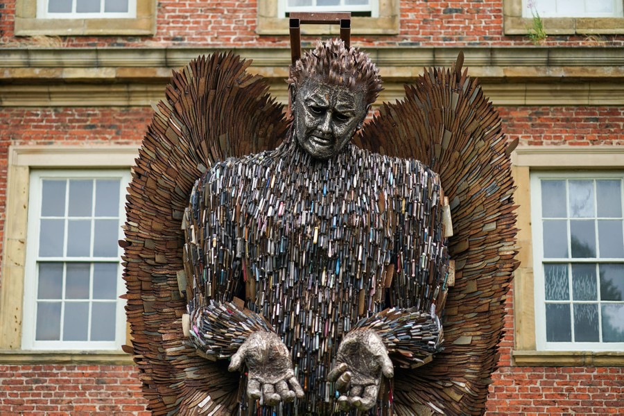 A large statue, shaped like an angel, made of thousands of knives