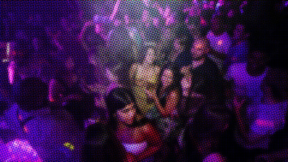 Fuzzy image of people dancing at an indoor party