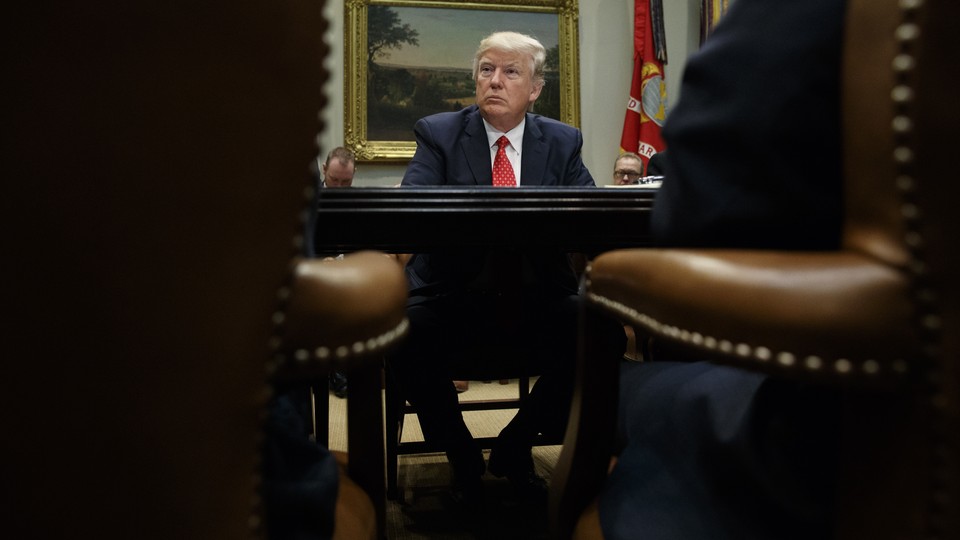 President Donald Trump listens during a meeting with county sheriffs in the Roosevelt Room of the White House.