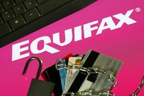 A keyboard, credit cards, chain, and padlock next to the Equifax logo