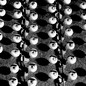 Black-and-white photo showing a mass-produced batch of wide-open eyeballs