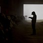 a silhouetted person in a barn