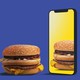 A burger looks at its reflection in an iPhone screen
