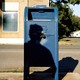 The shadow of a man over a mailbox