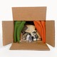 A cardboard box contains a collection of artifacts, including a photo of Malcolm X
