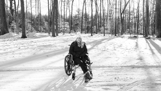 Photo of Caitlin Barber in wheelchair in snow