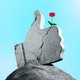 Giant rock thumb with a flower growing out of it