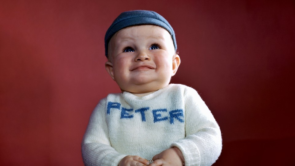 A baby with a shirt that says Peter