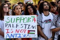 Students holding a sign in support of Palestine.