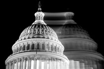 The Capitol is shown in black-and-white, with its blurry, shifted mirror image superimposed.