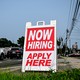 Photo of a "Now Hiring" sign.