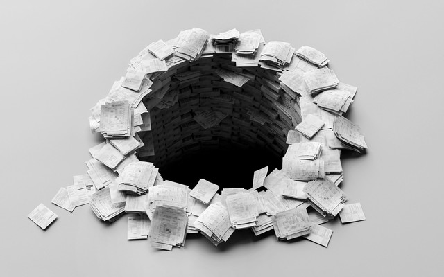 A black-and-white photo-illustration of sets of white paper packets, resembling printed research papers, stacked in a circle with a hole in the center plummeting into darkness.