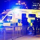 Armed police officers stand near the Manchester Arena. 