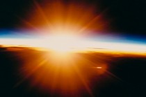 The sun shines brightly over the Earth's atmosphere