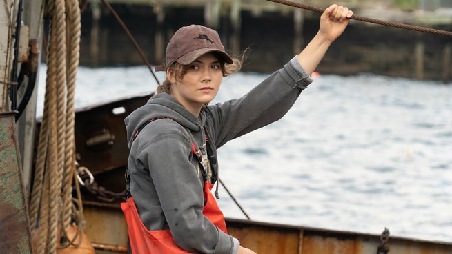 A teenager named Ruby sitting on a fishing vessel in the movie CODA