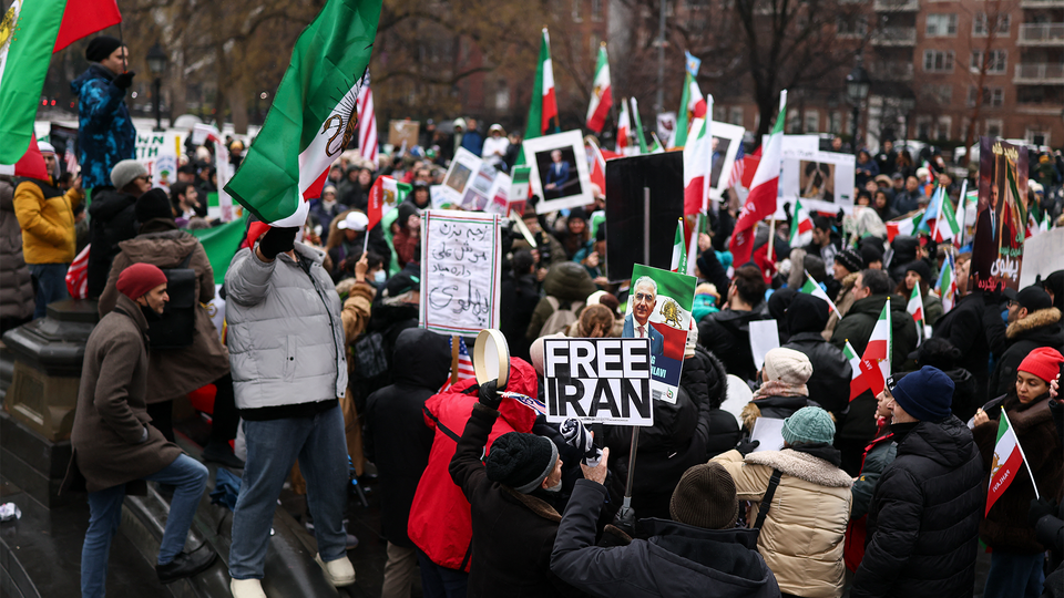 Protesters in New York City carry Iranian royalist flags and placards.