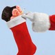 An illustration of a birthday cupcake being placed into a Christmas stocking.
