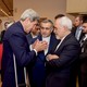 U.S. Secretary of State John Kerry speaks with Hossein Fereydoun, the brother of Iranian President Hassan Rouhani, and Iranian Foreign Minister Javad Zarif before addressing an international press corps on the nuclear deal on July 14, 2015.