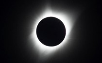 A photograph of the total solar eclipse in 2017, with the sun's corona glowing brightly against a dark sky